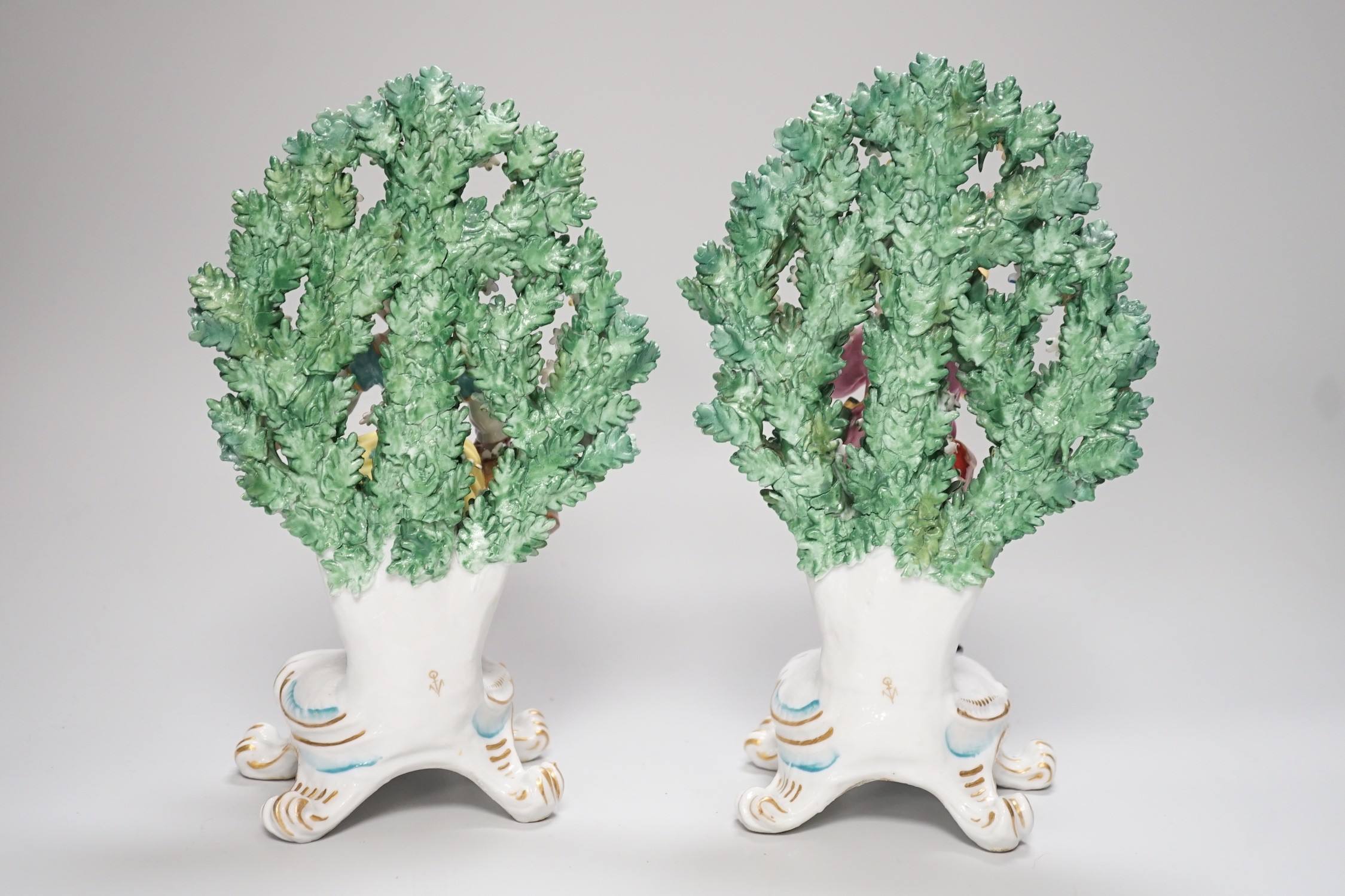 A pair of Derby style bocage figures and three other figures, tallest 26cms high
